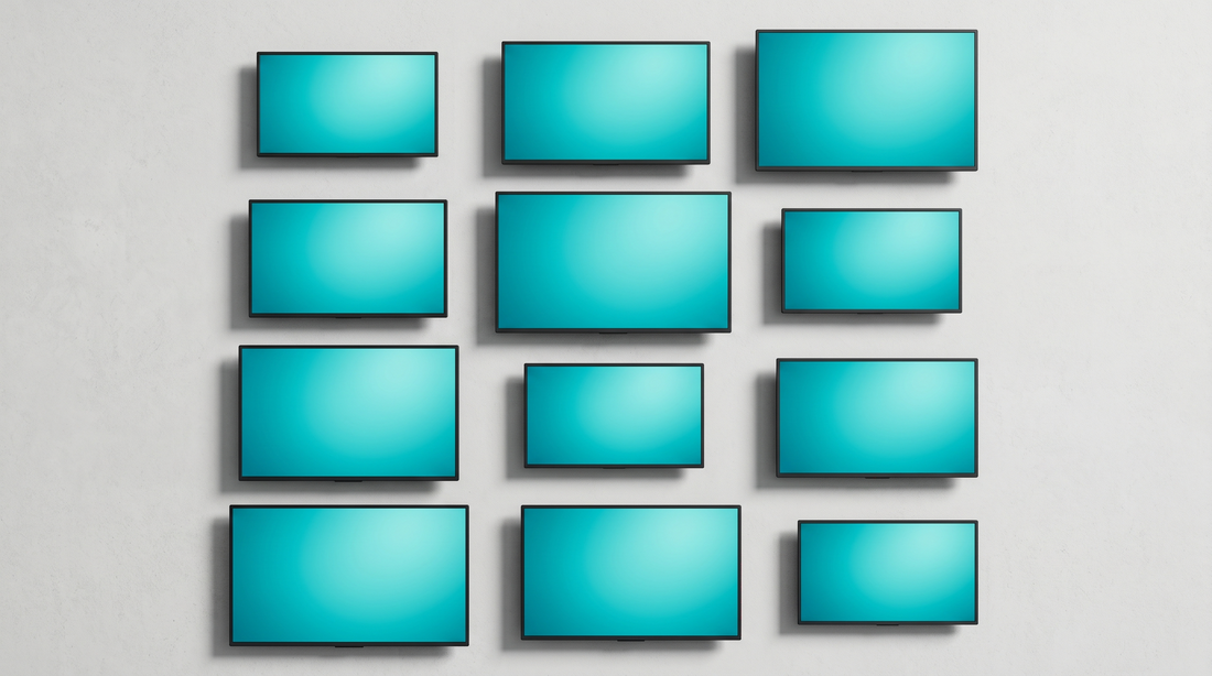 Overhead editorial product photography of commercial flat-panel displays of varying sizes representing digital signage hardware pricing tiers